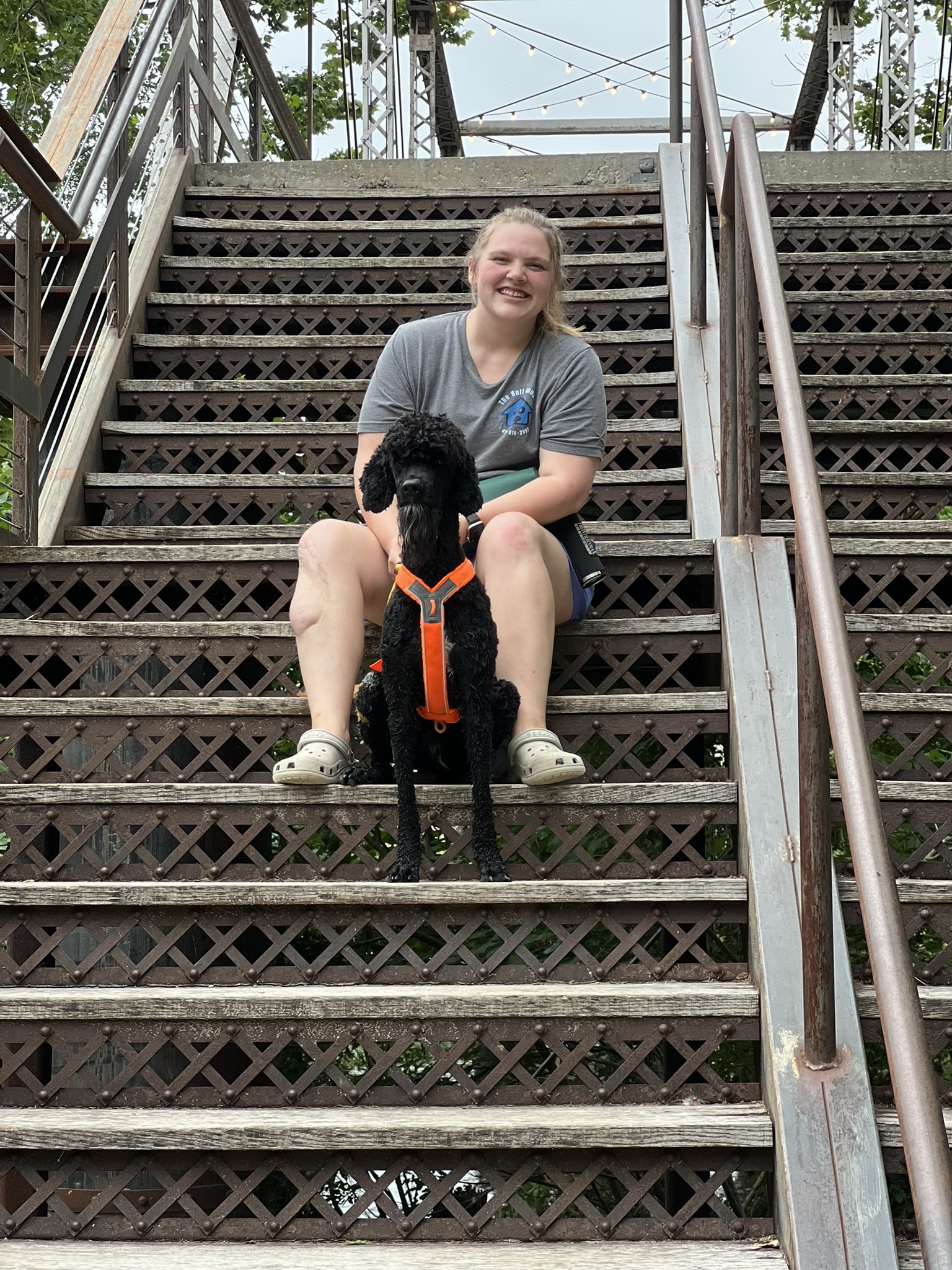 Mahlorie sitting with Bo on outdoor stairs